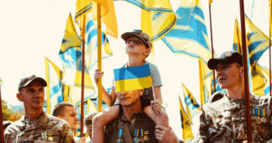 Azov Regiment veterans, whose banners carry an emblem derived from a Nazi symbol, the Wolfsangel, march in Kiev in 2019. Photo: Maxim Dondyuk / TIME.