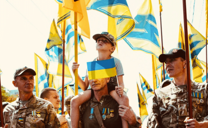 Azov Regiment veterans, whose banners carry an emblem derived from a Nazi symbol, the Wolfsangel, march in Kiev in 2019. Photo: Maxim Dondyuk / TIME.