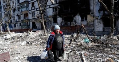 Featured image: A resident walks past a damaged building in Mariupol, March 28, 2022. Photo: Victor/Xinhua