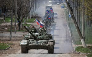 An armored convoy of troops moves along a road during Ukraine-Russia conflict in the southern port city of Mariupol. Photo: Reuters.