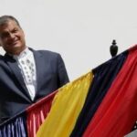 Featured image: Rafael Correa, former president of Ecuador, walks up a staircase with the flag of Belgium hanging from the railing. Photo: EFE