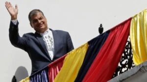 Featured image: Rafael Correa, former president of Ecuador, walks up a staircase with the flag of Belgium hanging from the railing. Photo: EFE