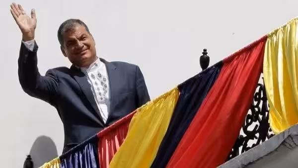 Featured image: Rafael Correa, former president of Ecuador, walks up a staircase with the flag of Belgium hanging from the railing. Photo: EFE