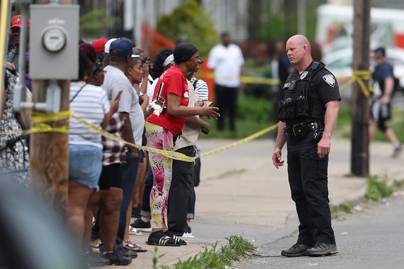 Featured image: An Officer speaks to distressed bystanders near the scene of the mass shooting in Buffalo, New York, Unite States on May 14, 2022, AP.