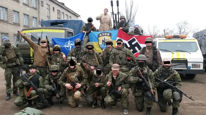 Featured image: Ukrainian neo-nazis pose with weapons and flags carrying nazi symbols as well as a NATO flag. File photo.