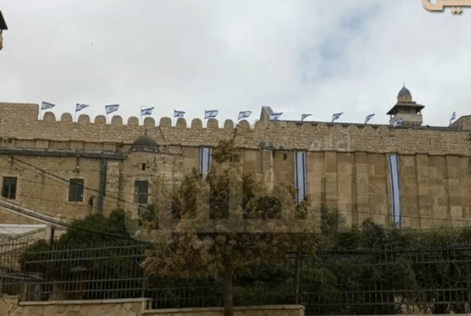 Featured image: Jewish settlers raised the Israeli flag atop the Ibrahimi Mosque in Hebron. Photo: via Palinfo.