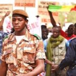 People protesting in Mali with soldiers nearby. (VOA – N. Palus) – VOA – Public Domain.