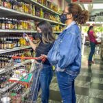 Three women in a supermarket alley in Venezuela doing groceries. File photo: EFE.