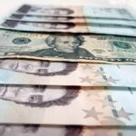 Several bolivar bills along a 20 dollar bill. File photo.