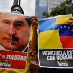 Venezuelan Primero Justicia extreme-right political party activists during a micro-protest in Caracas, holding placards comparing President Nicolas Maduro with Russian President Vladimir Putin. March 4, 2022. Photo: Federico Parra/AFP via Getty Images.