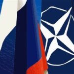 Featured image: Russia's flag and the flag of the North Atlantic Treaty Organization (NATO).