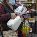 A shopper holds groceries while waiting to checkout inside a grocery store in San Francisco, California, U.S., on Monday, May 2, 2022. Photographer: David Paul Morris/Bloomberg.