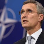 NATO's general secretary, Jens Stoltenberg, with the military organization logo in the background. Photo: AFP.