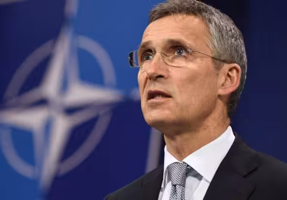 NATO's general secretary, Jens Stoltenberg, with the military organization logo in the background. Photo: AFP.