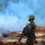 A member of the Brazilian army looks on as forest fires engulf a large part of the Amazon. Photo: Revista Opera.