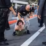 Unidentified US activist being beaten by policeman in Los Angeles. Photo: Apu Gomes/AFP/Getty.