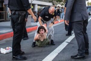 Unidentified US activist being beaten by policeman in Los Angeles. Photo: Apu Gomes/AFP/Getty.
