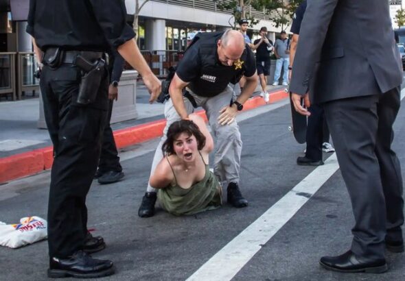Unidentified US activist being beaten by policeman in Los Angeles. Photo: Apu Gomes/AFP/Getty.