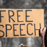 Person holding a placard that reads “Free speech.” File photo: Shutterstock.
