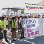 The march about to start with People’s Summit banner along with a banner of solidarity with Venezuela. Photo: Rick Sterling.