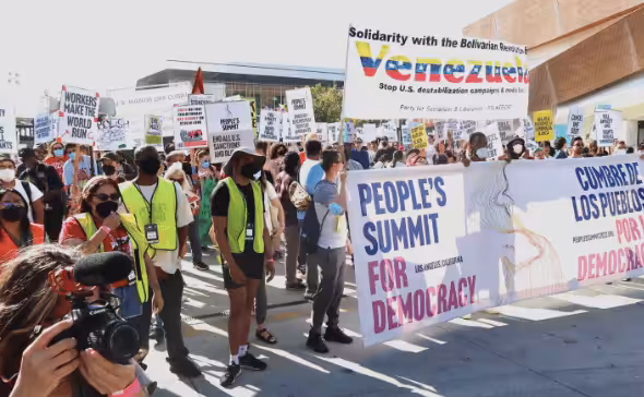 The march about to start with People’s Summit banner along with a banner of solidarity with Venezuela. Photo: Rick Sterling.