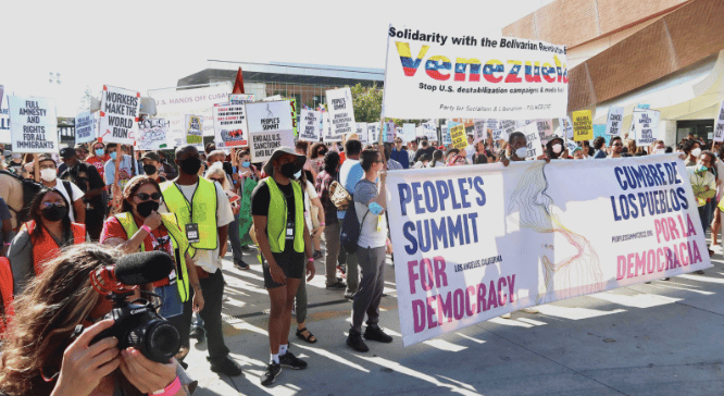 The march about to start with People’s Summit banner along with a banner of solidarity with Venezuela. Photo: Rick Sterling.