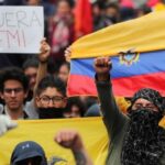 Protesters in Ecuador in 2019 holding a Fuera IMF [IMF get out] banner and the Ecuadorian flag, rallying against then President Lenin Moreno's submissive position towards the IMF. File photo.