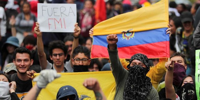 Protesters in Ecuador in 2019 holding a Fuera IMF [IMF get out] banner and the Ecuadorian flag, rallying against then President Lenin Moreno's submissive position towards the IMF. File photo.
