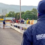 Colombian migration agent watching the passing of Colombian nationals towards Venezuela, at Simón Bolívar bridge near Cúcuta. File photo: Migracion Colombia.