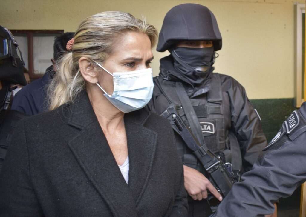 Former de facto President of Bolivia, Jeanine Áñez, surrounded by police in prison. File photo.