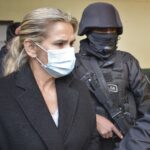 Former de facto President of Bolivia, Jeanine Áñez, surrounded by police in prison. File photo.