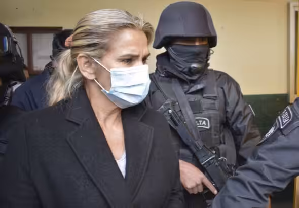 Former de facto President of Bolivia, Jeanine Áñez, surrounded by police in prison. File photo.