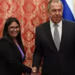 Russian Foreign Minister Sergey Lavrov shakes hands with Venezuela's VP Delcy Rodríguez.