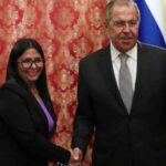 Russian Foreign Minister Sergey Lavrov shakes hands with Venezuela's VP Delcy Rodríguez.