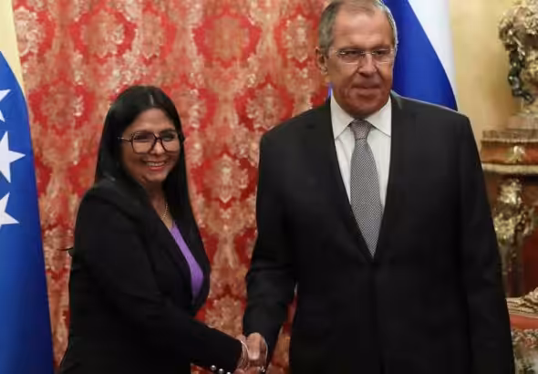 Russian Foreign Minister Sergey Lavrov shakes hands with Venezuela's VP Delcy Rodríguez.