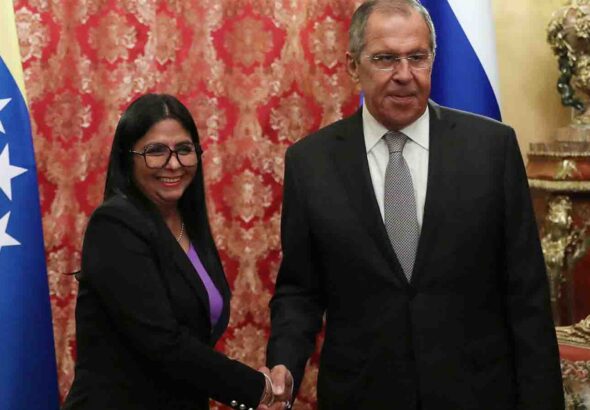 Russian Foreign Minister Sergey Lavrov shakes hands with Venezuela's VP Delcy Rodríguez.
