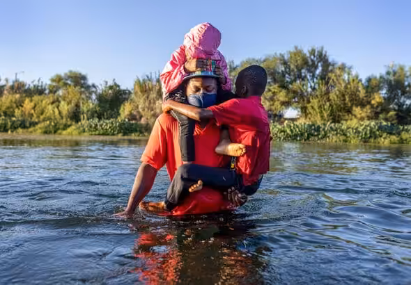 Seeking refuge: a Haitian family cross the Rio Grande into Texas, September 2021. John Moore · Getty