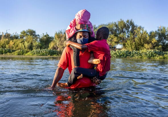 Seeking refuge: a Haitian family cross the Rio Grande into Texas, September 2021. John Moore · Getty