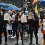 Young Colombian protesters holding placards with the names of protesters "disappeared" during Colombian general strike in 2021. Photo: AFGJ.