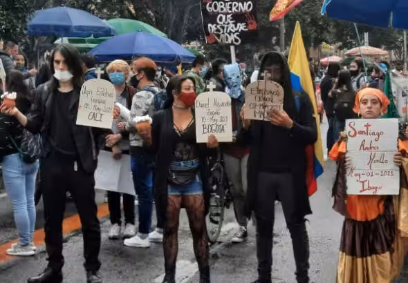 Young Colombian protesters holding placards with the names of protesters "disappeared" during Colombian general strike in 2021. Photo: AFGJ.
