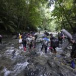 Featured image: Migrants cross the Acandi River on their journey north, near Acandi, Colombia, on Wednesday, September 15, 2021. The migrants, mostly Haitians, are on their way to crossing the Darién Gap, from Colombia into Panama, and ultimately dream of reaching the US. Photo: AP/Fernando Vergara.