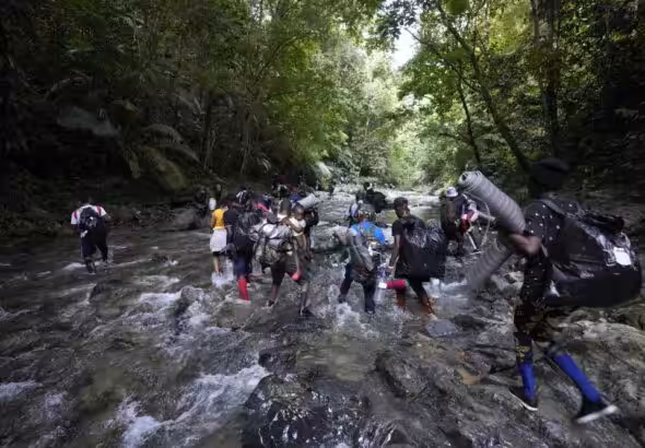 Featured image: Migrants cross the Acandi River on their journey north, near Acandi, Colombia, on Wednesday, September 15, 2021. The migrants, mostly Haitians, are on their way to crossing the Darién Gap, from Colombia into Panama, and ultimately dream of reaching the US. Photo: AP/Fernando Vergara.