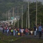 People walking through a blockaded road in Panama. Photo: AP.