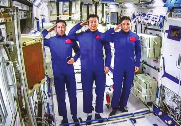 The Shenzhou-14 crew members, Chen Dong (center), Liu Yang (right) and Cai Xuzhe salute from the Wentian (Quest to The Heavens) lab module on July 25, 2022 from some 400 kilometers above the Earth. The three taikonauts checked in to their office and home unit in space at 10:03 am. Photo: cnsphoto.