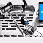 Photo composition showing a smartphone with a blue screen reading “Uber” next to a gavel representing judicial processes and a car’s back mirror with a “decorative” skull hanging from it. Photo: El Pais/Patricia Bolinches.