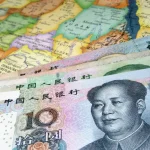 Photo composition showing Yuan bills over a map of Africa. Photo: Shutterstock.