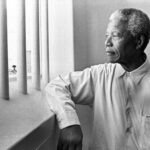 Nelson Mandela revisiting his jail cell in Robben Island Prison. File photo.
