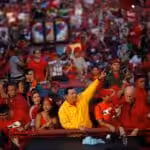 Comandante Hugo Chávez surrounded by people during a political rally. File photo.