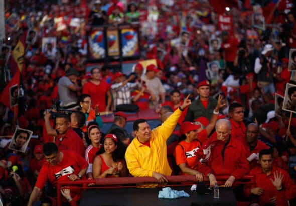 Comandante Hugo Chávez surrounded by people during a political rally. File photo.