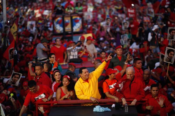 Comandante Hugo Chávez surrounded by people during a political rally. File photo.